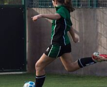 female player strikes ball